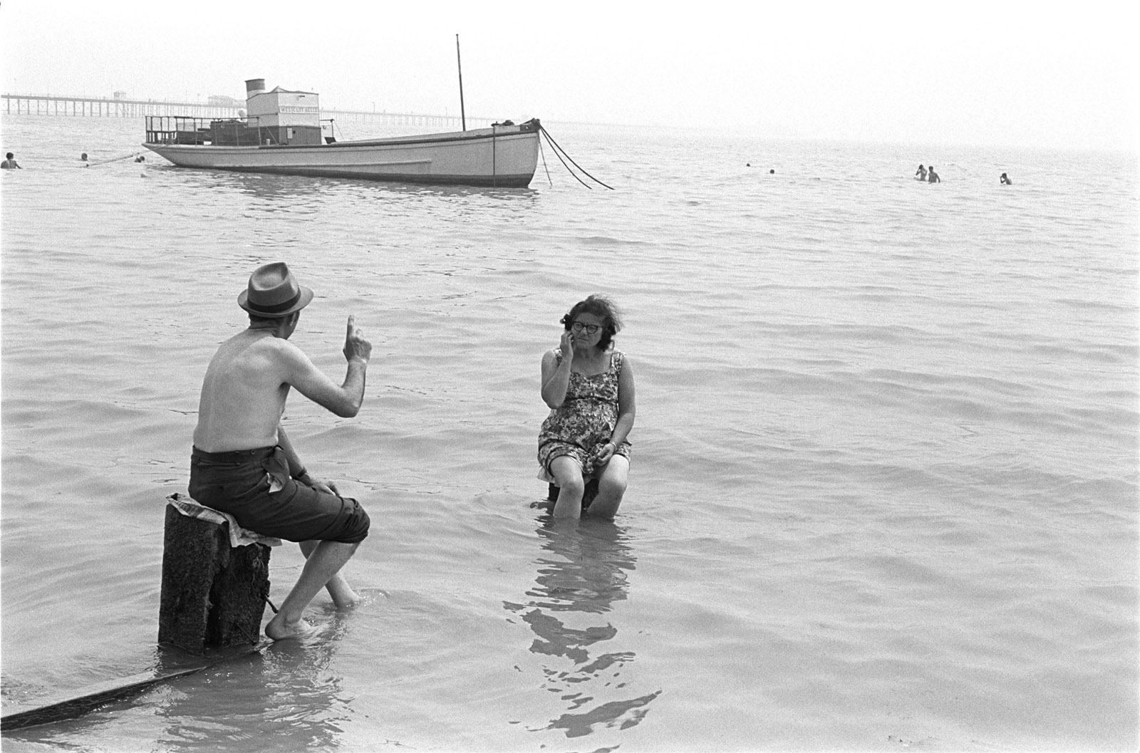 Couple ignoring the incoming tide, Southend on Sea, Essex, 1969