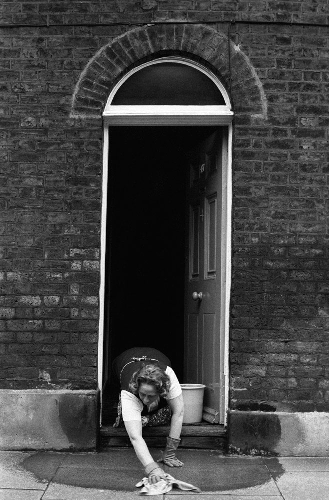 House proud, washing pavement, Waterloo, London, 1975