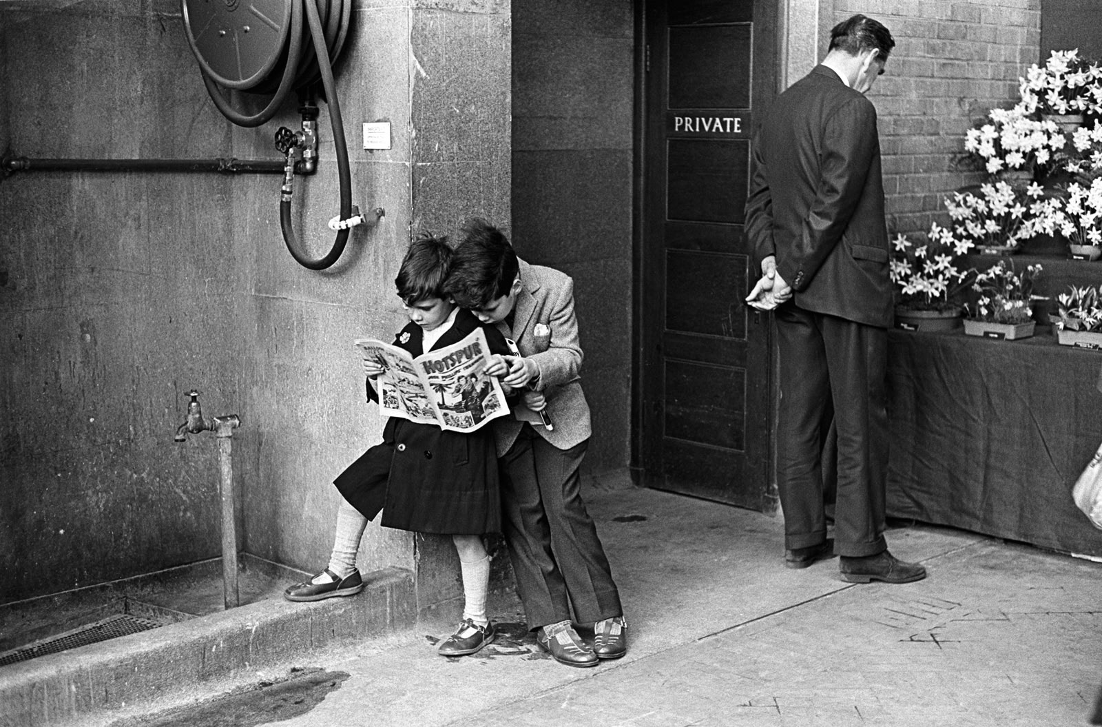 Two young boys reading Hotspur comic at the Royal Horticultural Society Flower Show, Victoria, London, 1968