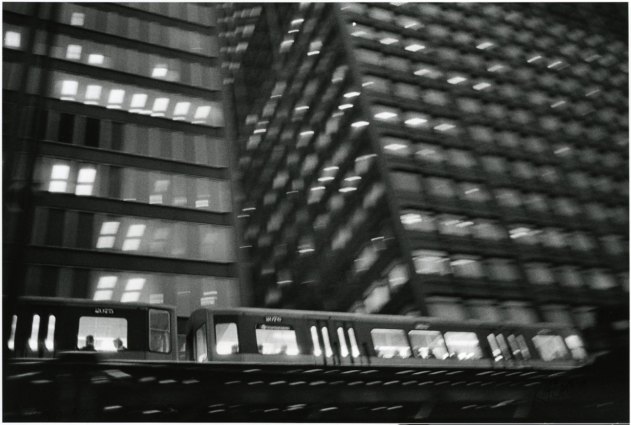 Blurry view of train and building, windows at night, Chicago, 1978
