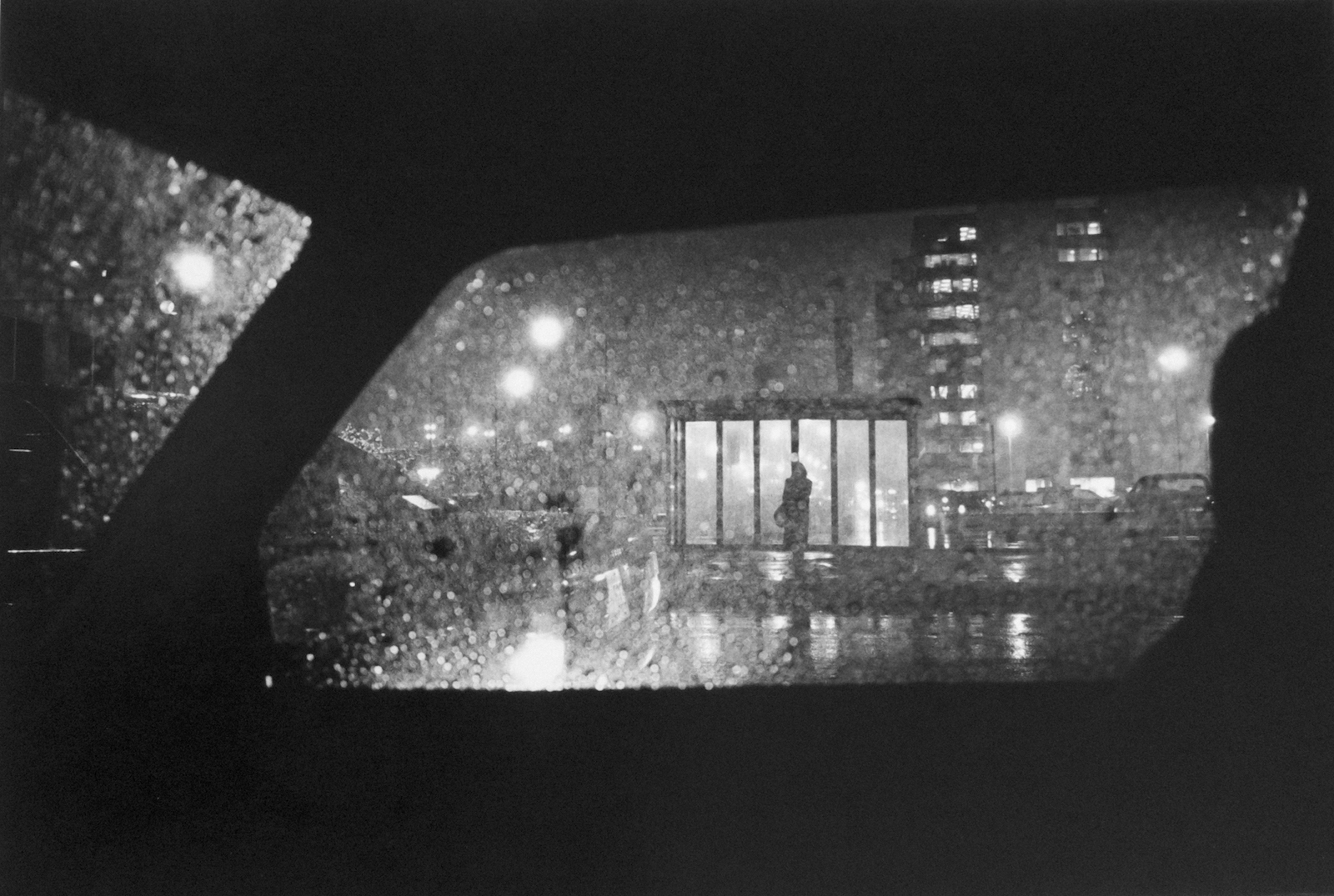 Woman at bus stop at night, Chicago, 1992