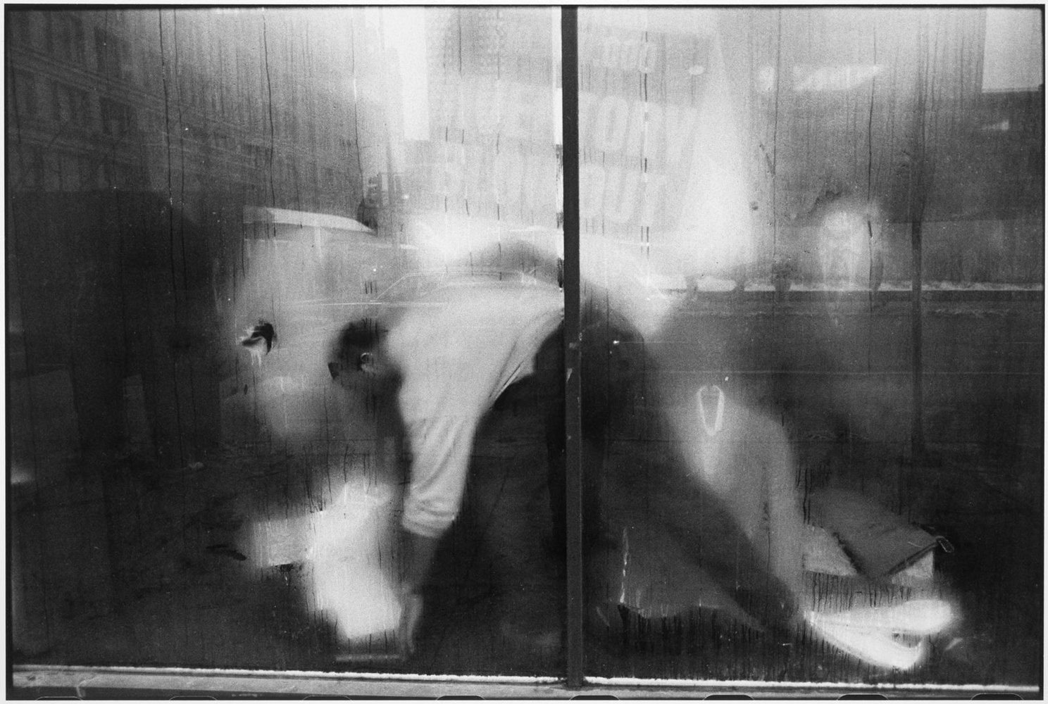 Man behind a store window, Chicago, 1990